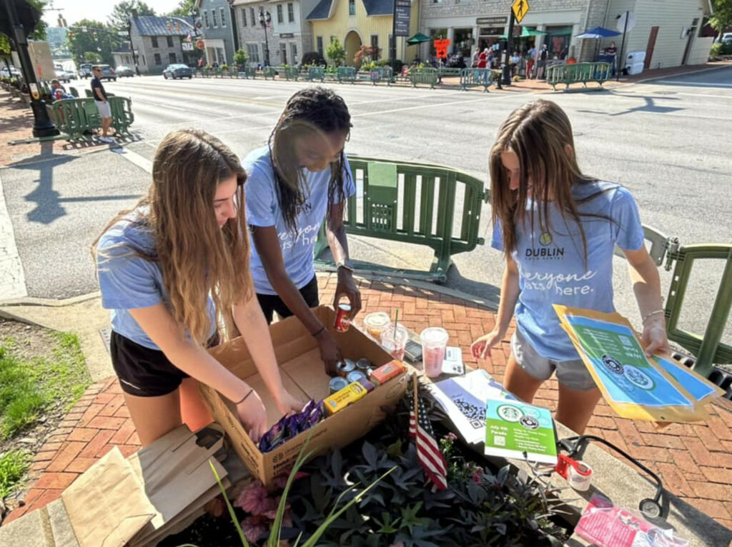 Girls sorting food at the Dublin Fourth of July Parade during a summer of giving.